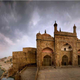 Alamgir’s Mosque: The most prominent Mughal monument in the holy city of Banaras is this mosque that emperor Aurangzeb erected in 1669. Built on a terrace high above Panchaganga Ghat, it can be reached by a steep flight of steps from the river below. The vertical proportions of the prayer hall’s triple-bayed facade were once accentuated by a pair of slender corner minarets that rose 50 metres above the terrace, but they do not exist any longer. Battlements conceal three domes of almost equal height, chhatris (elevated dome-shaped pavilions) at the rear corners serve as lookouts. The interior, which comprises a line of only three chambers, is roofed by domes with intricate plaster decoration.